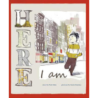 A young boy walks through a city.