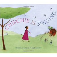 A young African girl in a red dress crosses a hill while singing.