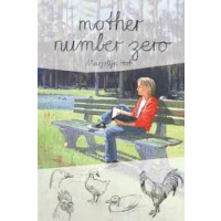 A lady is sitting on a bench outside reading her book