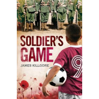 A kid is holding a soccer ball and staring at the army of soldiers infront of him