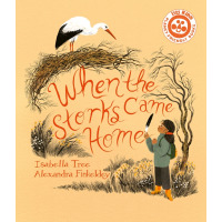 A young Black girl holds up a feather and looks at a stork in a nest. 