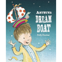 A young boy with a toy sail boat on his head.