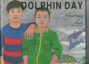 Two boys with dolphins swimming in the background
