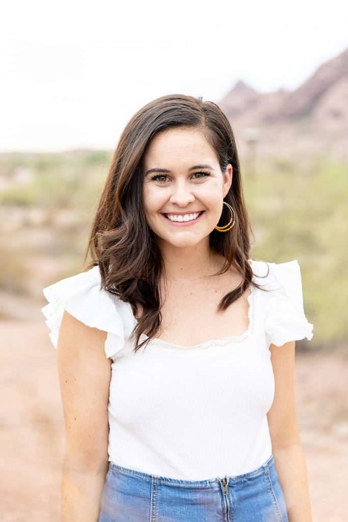 woman with long hair smiles to the camera