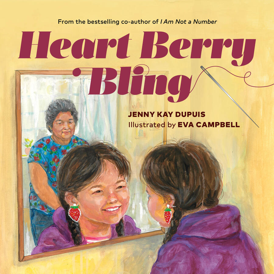 A young girl smiles into a mirror, admiring her new strawberry earrings.