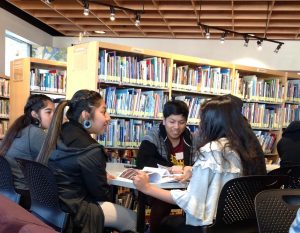 Students from Tohono O'odham High School engage in a lively discussion around a table