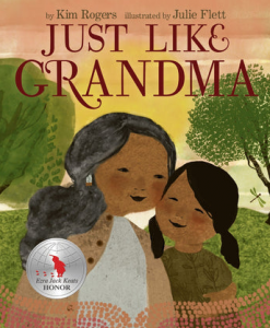 An Indian woman with long dark hair stands close to her granddaughter