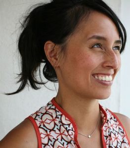Profile photo of LeUyen Pham with her black hair up against a bright white background