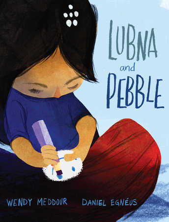 Lubna and Pebble cover depicts a girl sitting crisscross, drawing on a stone with a pencil.