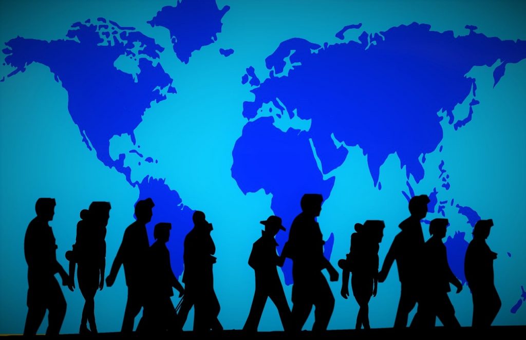 Decorative image of a blue wall featuring a world map with silhouettes of people walking past.