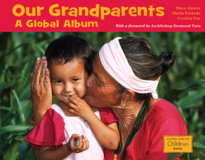 A brown-skinned older woman holds a smiling toddler