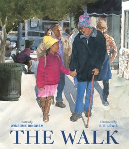 An old Black woman and a young Black girl hold hands as they walk down a city street.