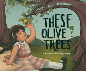 A young girl reaches up to touch the olive at the end of a branch.