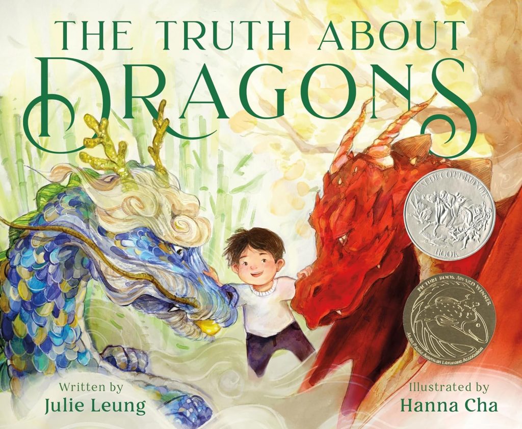 A young Asian boy stands between two dragons; one blue Asian dragon and one red European dragon.