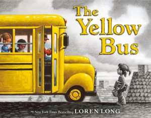 A child stands in front of a yellow school bus.