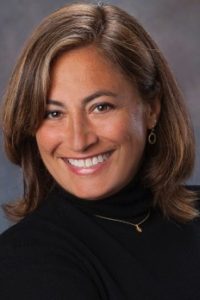 smiling portrait of Beth Ferry in black turtle neck shirt