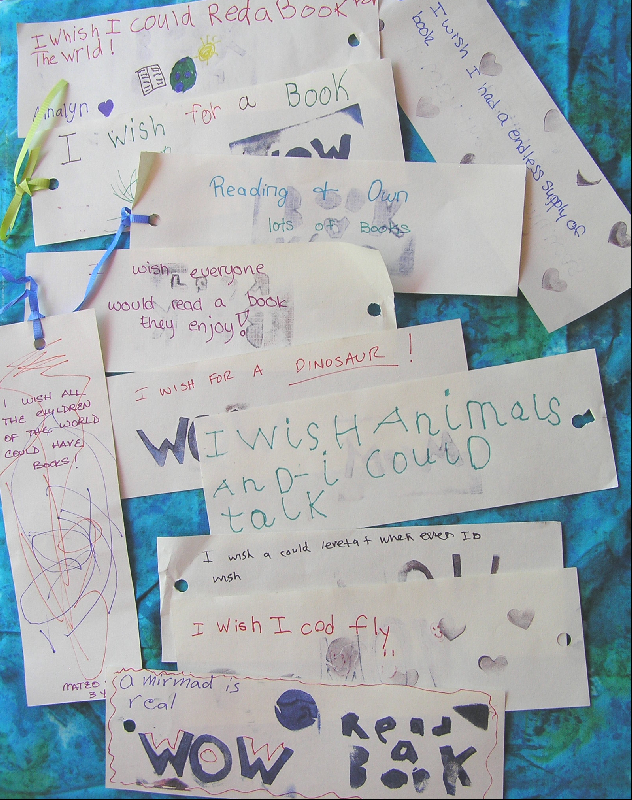 Bookmarks created by young people indicating wishes about talking to animals, desire to fly, that mermaids could be real, and to read a book to the world.