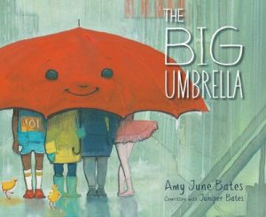 A big red umbrella with several people underneath