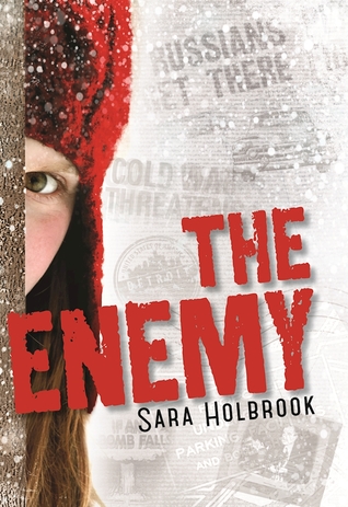 Cover of The Enemy depicting a child in a red hat peeking out from behind a wall in the snow. The background is full of faded news paper headlines.